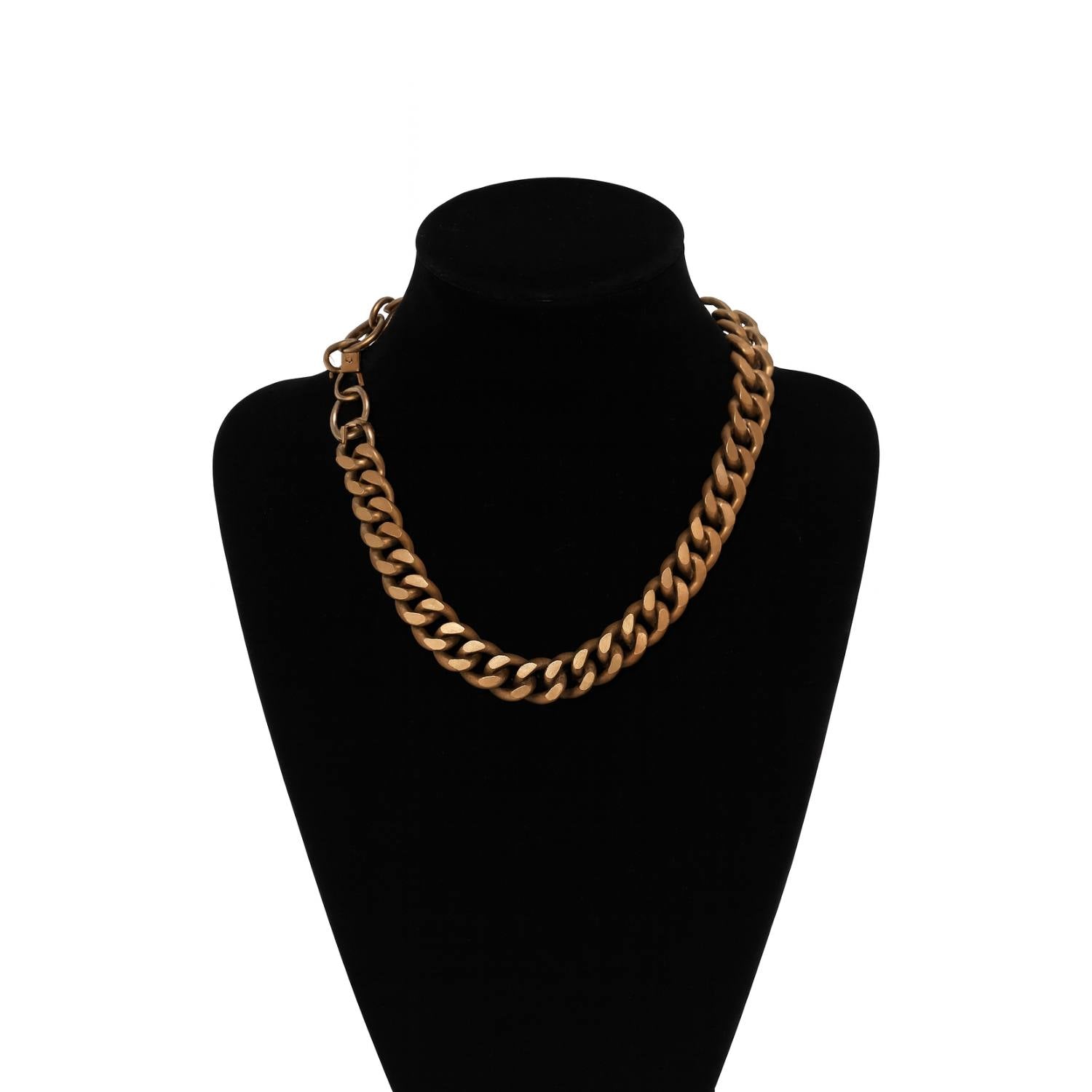 Gold chain necklace on a black mannequin bust against a white background