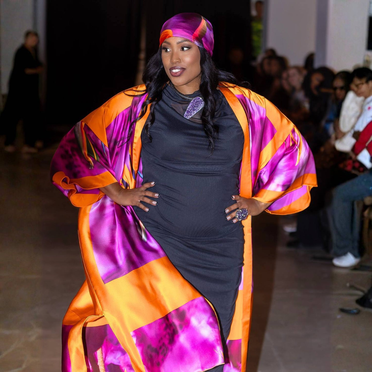 Woman on the runway in a Bird of Paradise Pink Purple Silk Kimono  and matching headscarf against blurred background