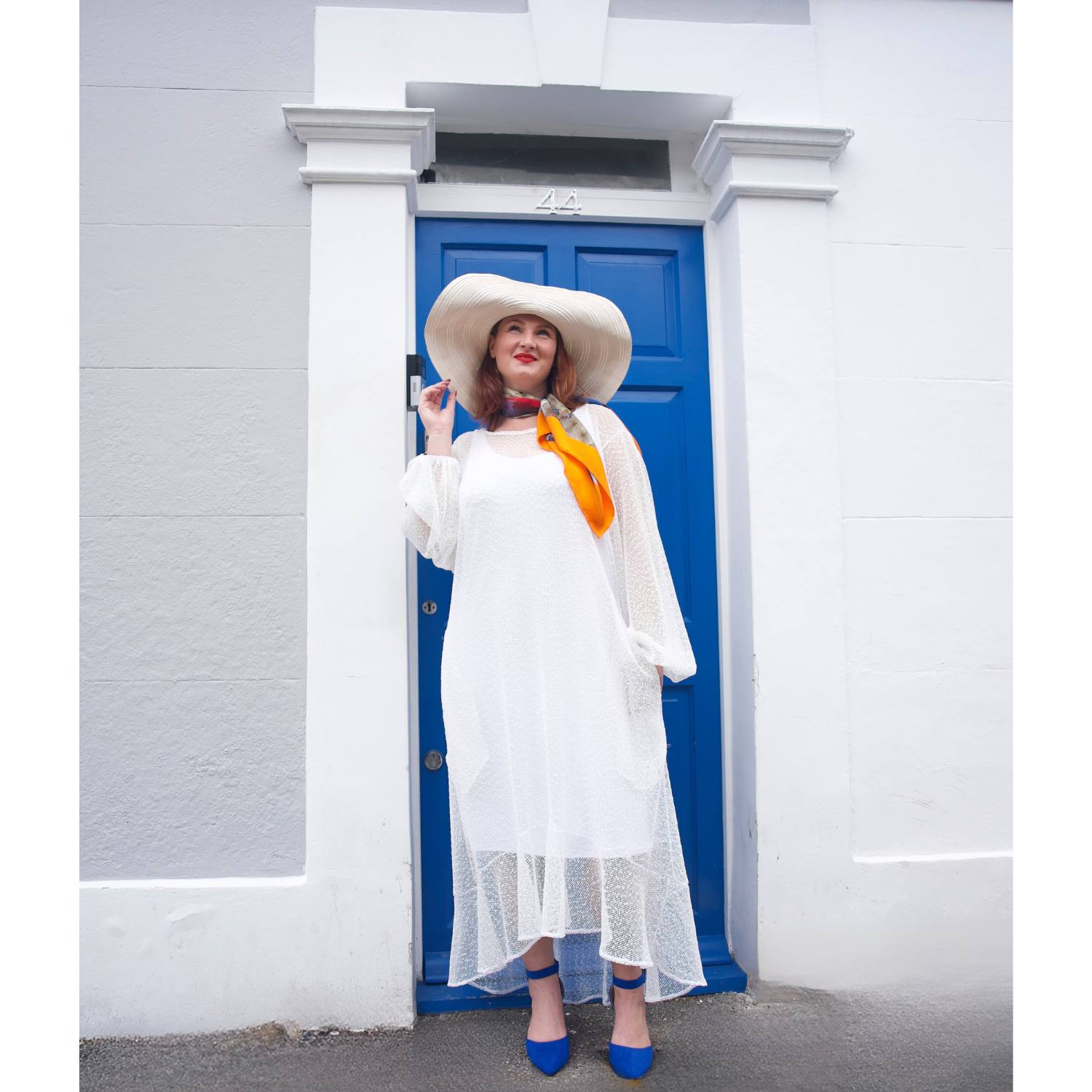 Women's Plus Size Aphrodite White Holiday Resort Dress with a white undergarment, paired with a white sunhat, the Cherry Blossom Silk Scarf and blue heels.