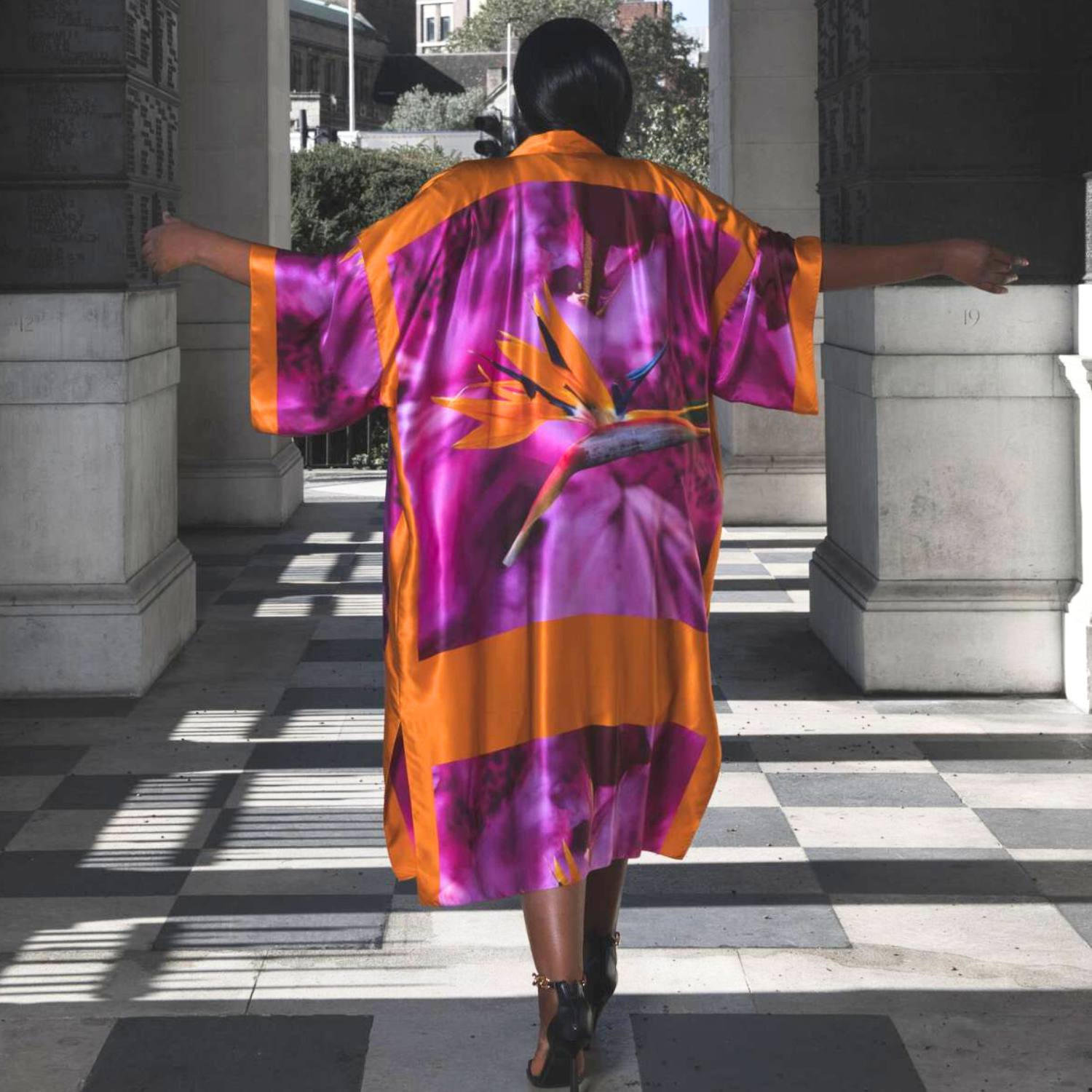 Bird of Paradise Pink Purple Plus Size and Mid Size Silk Kimono shown from the back, with the model wearing heels for an elegant appearance.