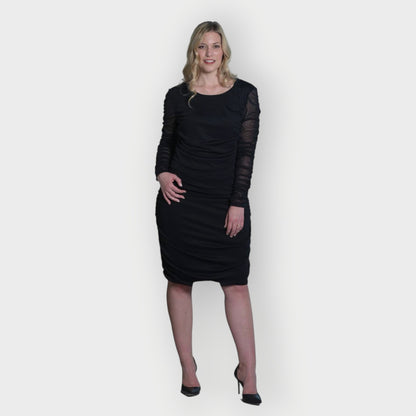 Women's Black Mid Size Ruched Bodycon Midi Dress styled with black heels for a classic and elegant touch.