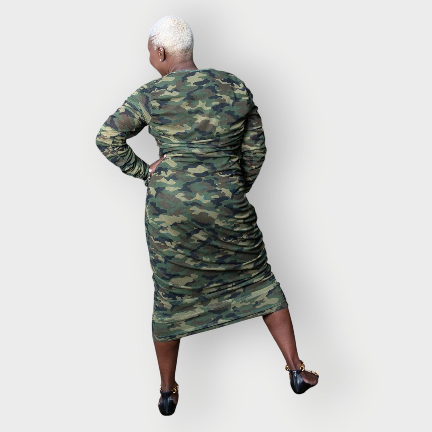 Women's Plus Size Olive Green Camouflage Bodycon Midi Dress styled with gold chain heels for a sophisticated touch.
