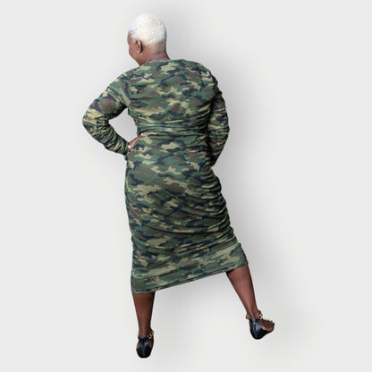Women's Plus Size Olive Green Camouflage Bodycon Midi Dress styled with gold chain heels for a sophisticated touch.