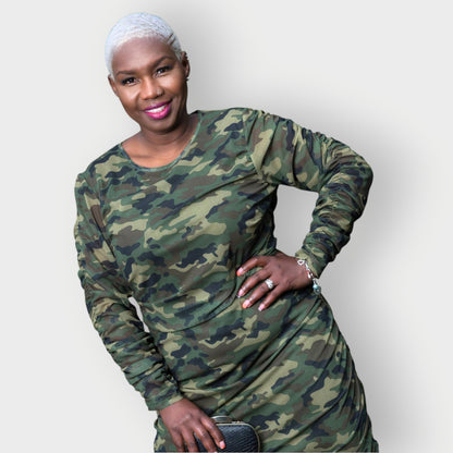 Women's Plus Size Olive Green Camouflage Bodycon Midi Dress styled with a black and gold clutch for a sophisticated touch.