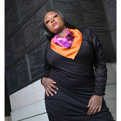 Women's Black Plus Size Ruched Bodycon Midi Dress shown as a close up, styled with a pink purple silk scarf for a pop of color and a chic look.