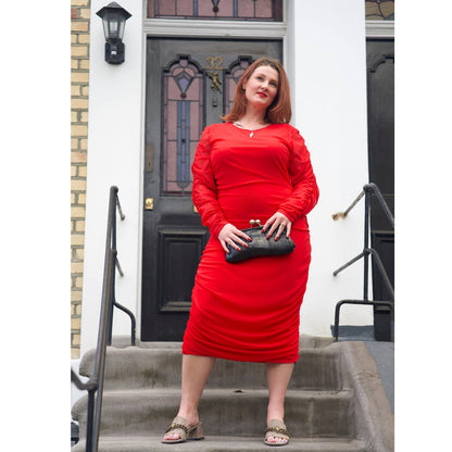 Women's Red Plus Size Ruched Bodycon Midi Dress styled with silver jewelry by Veronique Designs, black clutch, and gold Kurt Geiger sandals.