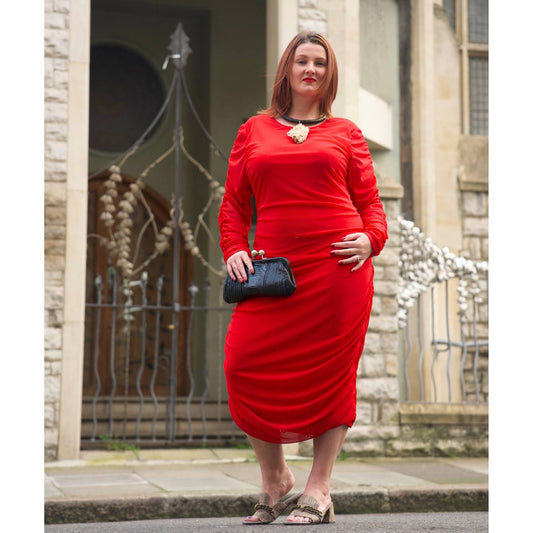 Women's Red Plus Size Ruched Bodycon Midi Dress styled with quartz jewelry by Veronique Designs, black clutch, and gold Kurt Geiger sandals.