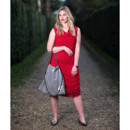 Women's Boudicca Summer Red Ruched Bodycon Midi Dress styled with a silver  handbag and Silver flats for a chic, modern ensemble.