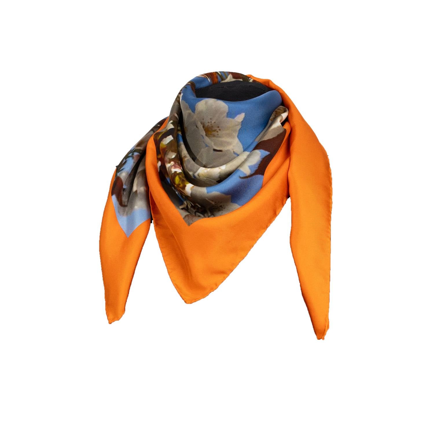 Silk scarf with Orange Bird of Paradise and White-Blue Cherry Blossom print, displayed as a cutout around an invisible mannequin's neck to highlight its intricate design.