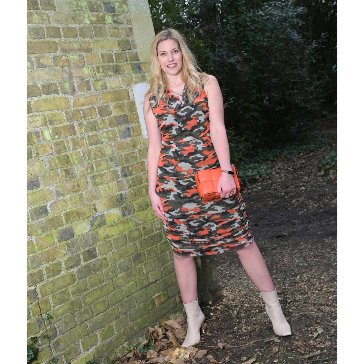 Women's Summer Mid Size Orange Green Grey Camouflage Bodycon Midi Dress styled with an orange handbag and beige boots for a modern, stylish look.