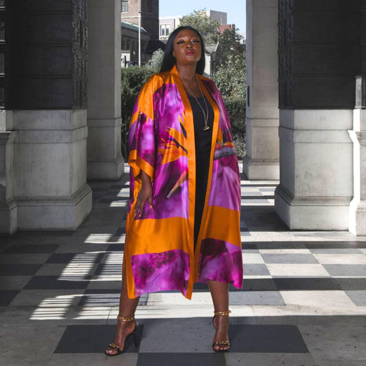 Women's Bird of Paradise Pink Purple Plus Size and Mid Size Silk Kimono styled with the Boudicca Black Dress and gold chain heels for an elegant look.