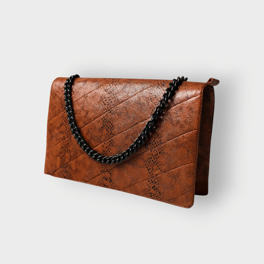Chocolate Brown textured clutch bag with black chain handle on a light gray background