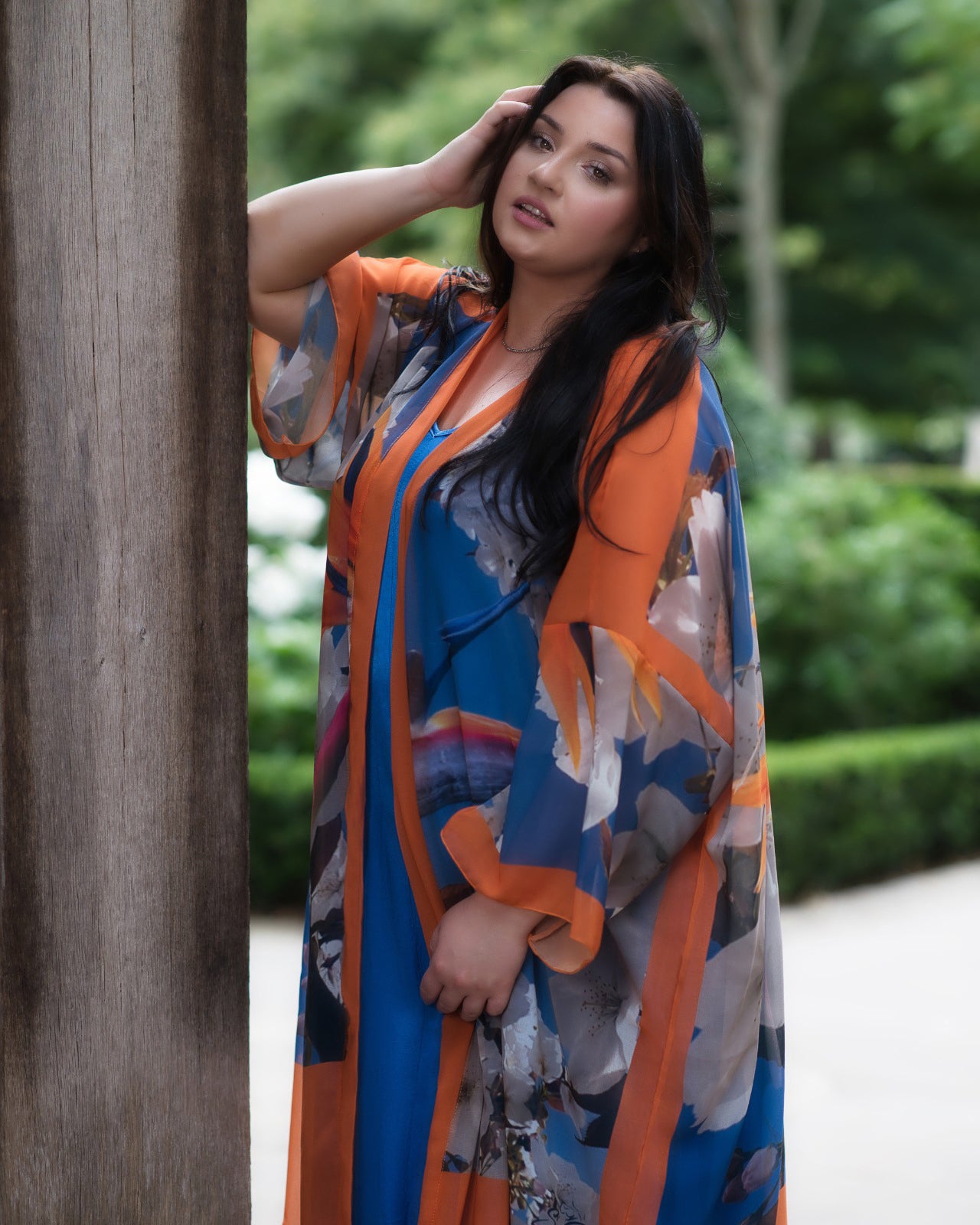 Women's White and Blue Plus Size Georgette Cherry Blossom Kimono shown from the side, styled with a blue dress.
