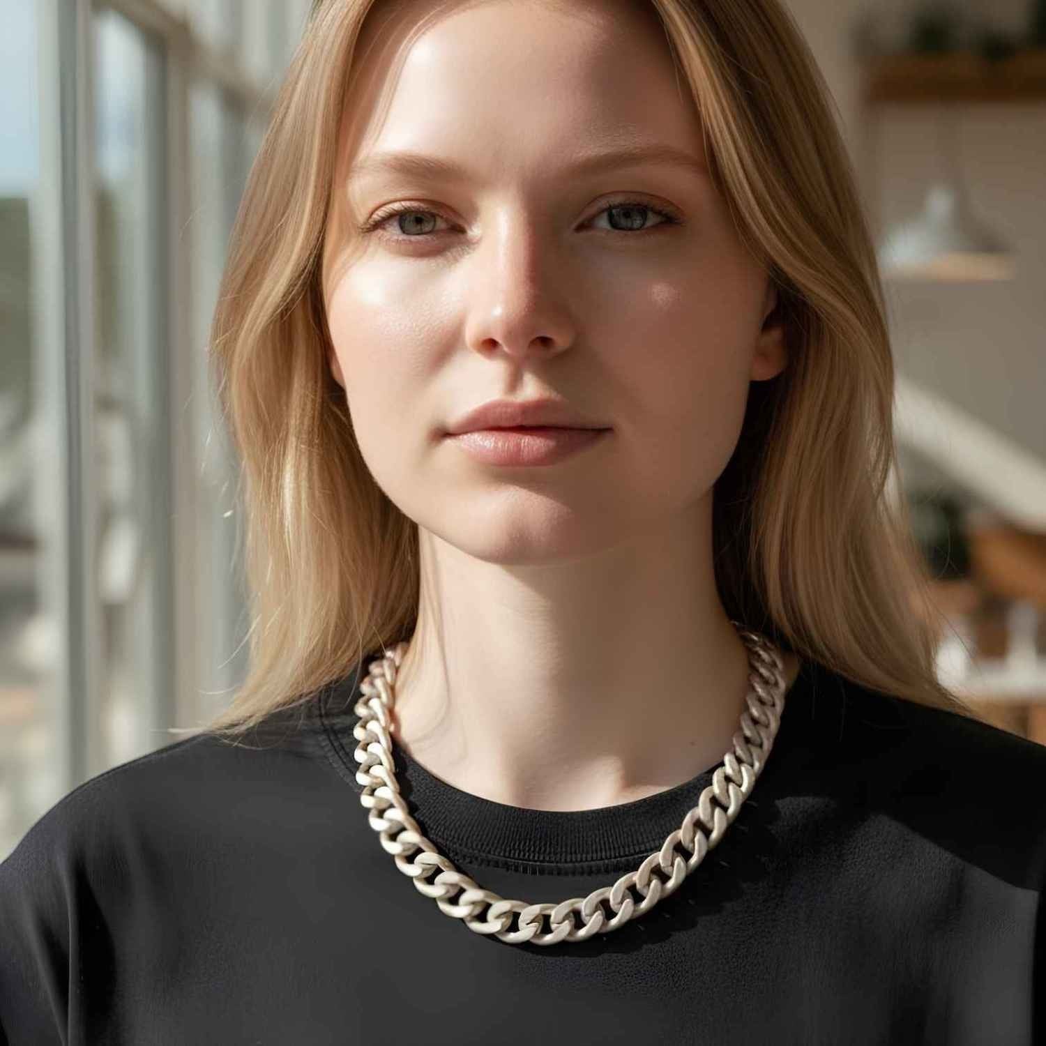 Sylvia Piechulla unisex chunky silver aluminium chain necklace worn by a model in a black top.