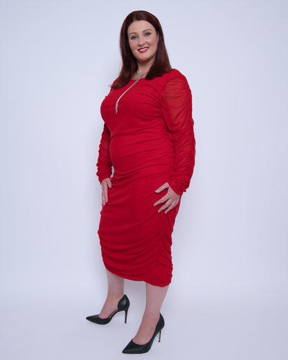 Women's Red Plus Size Boudicca Ruched Bodycon Midi Dress shown from the side, styled with black heels for a sophisticated, elegant look.